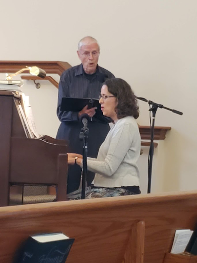 dick boshart performing at a church